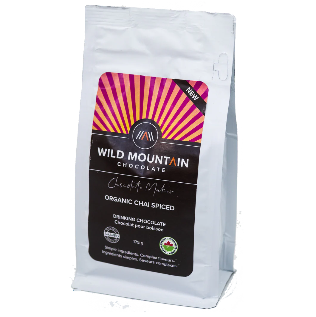 Wild Mountain Chocolate drinking chocolate and bars with rich cocoa and vibrant packaging on a wooden surface.