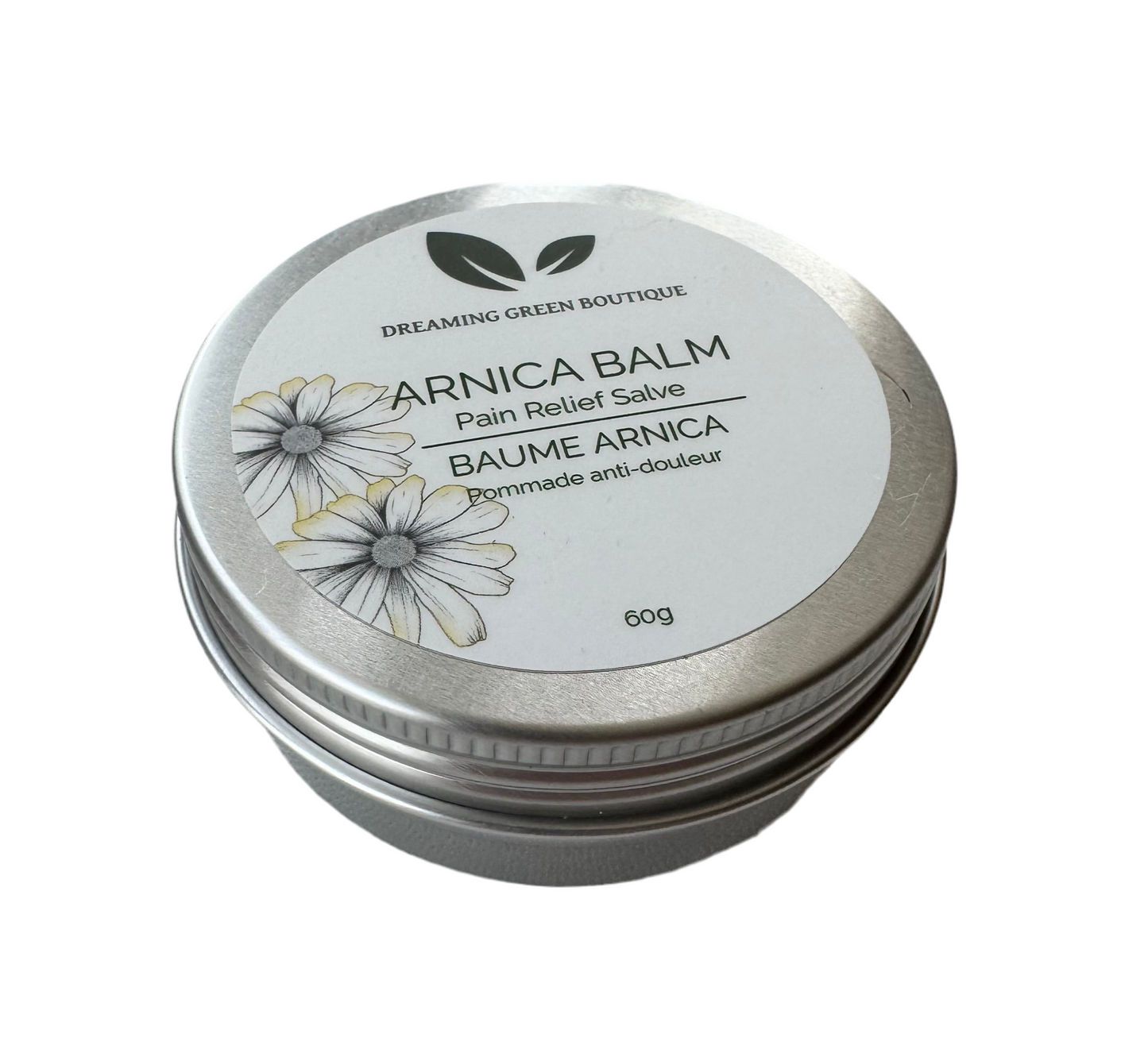 Arnica balm in a jar from Dreaming Green Boutique, showcasing a rich, creamy texture and natural ingredients.