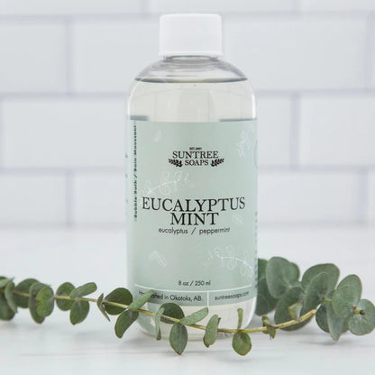 Suntree Soaps bubble bath in a clear bottle with bubbles and a calming scent, perfect for a relaxing soak.