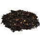 Creamy Earl Grey tea leaves in a clear jar from Jolene's Tea House, showcasing rich colors and texture.