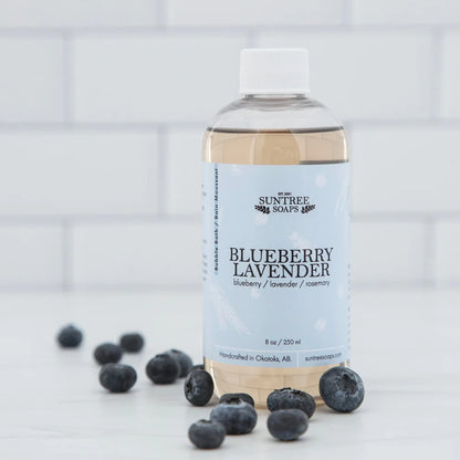 Suntree Soaps bubble bath in a clear bottle with colorful bubbles and a relaxing setting for a soothing bath experience.