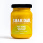 Smak Dab gourmet mustard jar with a rich yellow color and textured label, set against a neutral background.