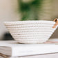 Small woven basket by Woven Handmade, featuring intricate patterns and a sturdy design, ideal for storage or decor.